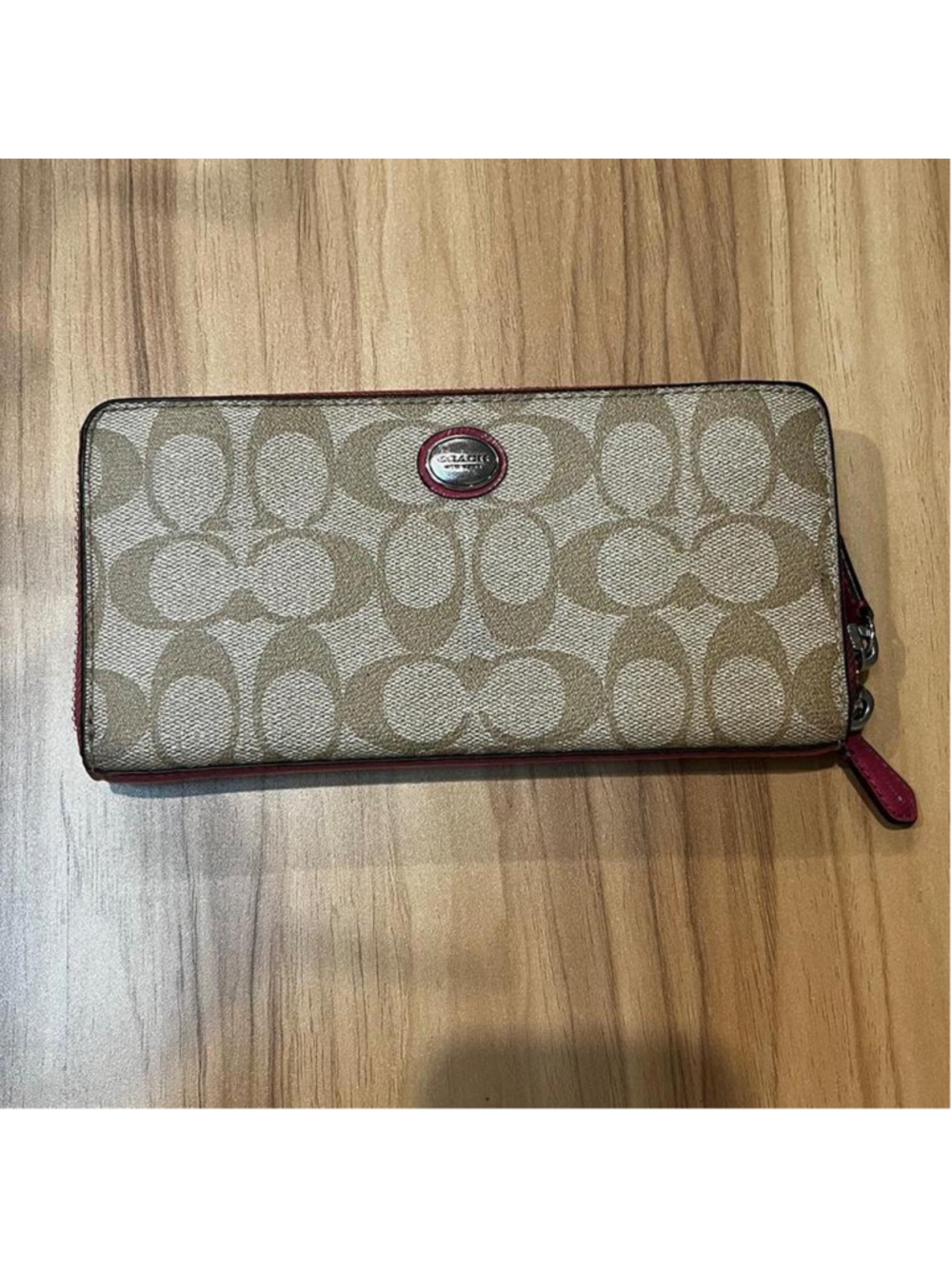 Coach Signature C zip-around wallet with pink trim and interior
